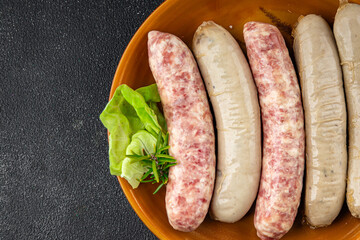 Wall Mural - sausages raw meat pork, beef, chicken, lamb fresh tasty food dish gourmet food background on the table rustic food top view copy space