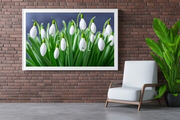 Fototapete - A large, white-framed photograph of blooming snowdrops adorns the wall in an industrial-style interior. In front, there is an armchair and a coffee table with green plants. The room has dark