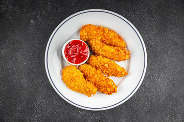 Wall Mural - Chicken nuggets deep fried breaded food dish fresh tasty gourmet food background on the table rustic food top view copy space