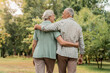 © InsideCreativeHouse - Rear view of senior couple walking outdoors in summer park and embracing, loving happy mature spouses hugging and smiling to each other, cheerful husband and wife enjoying outside walk, copy space