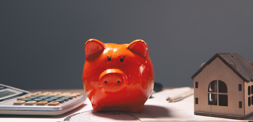 Wall Mural - piggy bank and house model on table