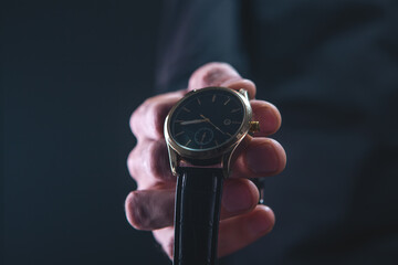 Wall Mural - a man in a black leather suit with a watch