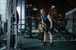 © Marko - Man Working Out On A Cable Machine In A Gym At Night
