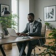 © WorkSphere - Successful African American Businessman Working at a Desk, African American Business Owner, CEO, Working From Home, African American Owned Business, Handsome Young Businessman