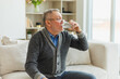 © Юлия Завалишина - Senior man holding glass drinking fresh water at home. Mature old senior thirsty grandfather takes care of his health. Healthcare water balance. Elderly healthy lifestyle