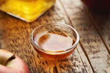 Wall Mural - Apple cider vinegar in a glass bowl