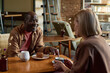 © TrueFrame Collective - Two People Enjoying Coffee and Pastries in Cafe