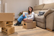 © unai - Woman relaxing on floor after moving into new apartment