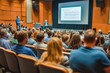 © wernerimages - The image captures a captivated audience during a presentation on stage, highlighting the importance of engagement and interaction in knowledge sharing and professional discourse.