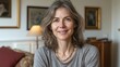 © BlackBird Studio - Smiling Mature Woman in Cozy Living Room Setting, Natural Light Portrait