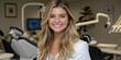 © aicandy - Portrait of a Smiling Woman in a Bright Dental Office Wearing a White Coat, Surrounded by Modern Dental Equipment and a Comfortable Patient Chair