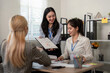© Natee Meepian - Financial professionals presenting tax analysis and planning strategies in a team meeting.