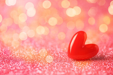 Sticker - Valentine's day greeting card. Small red heart on shiny pink glitter and bokeh lights. Space for text