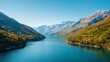 © JPminimal - Hydroelectric Power Station on a Serene River Mountainous Region Aerial View Nature's Beauty