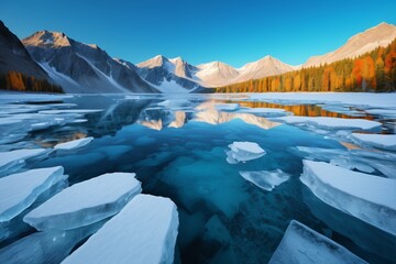 Wall Mural - mountains are reflected in the water of a lake surrounded by ice