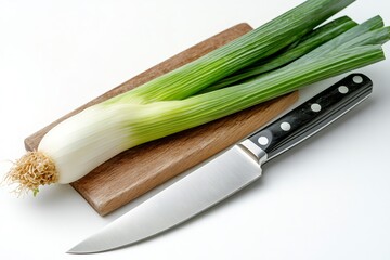 Wall Mural - Fresh leeks on cutting board with knife lying on white background