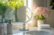 © LimeSky - Compact round makeup mirror by marble sink and steel faucet near a large glass window with concealed lighting Sleek modern white bathroom design