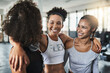 © peopleimages.com - Gym, friends and laughing with hug for training, support and solidarity with conversation for fitness. Team, women and happiness with embrace for exercise, wellness and cardio for health with workout