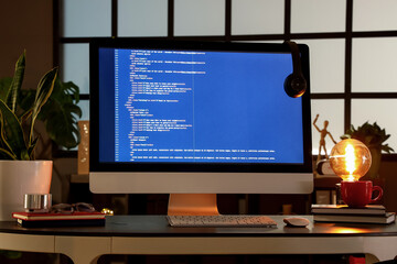 Wall Mural - programmer's workplace with computer in dark office