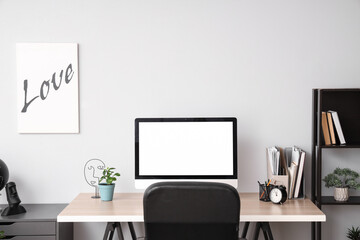 Wall Mural - blank computer monitor with alarm clock on table in office