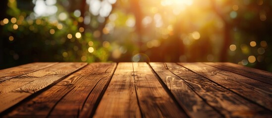 Aufkleber - Wooden table surface with warm sunlight glowing through blurred greenery in the background, creating a tranquil outdoor atmosphere.