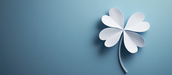 Poster - Minimalistic design featuring a large white shamrock positioned in the lower right corner against a soft blue backdrop highlighting color contrast