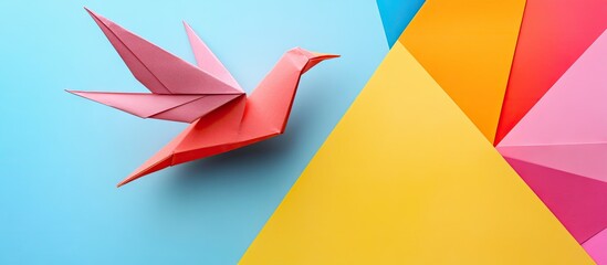 Poster - Colorful origami bird in pink positioned on blue and yellow geometric background with vibrant orange and red accents showcasing craft artistry.