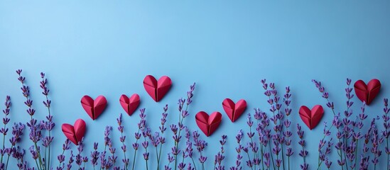 Poster - Lavender stems in purple arranged with red paper hearts on a light blue background creating a romantic Valentine's Day theme with space for text