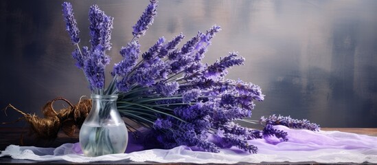 Aufkleber - Lavender bouquet in a glass vase with purple flowers and green stems on a soft white cloth against a blurred dark background