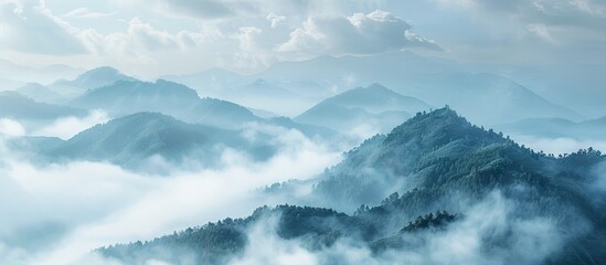 Aufkleber - Serene mountain landscape shrouded in mist with soft blue tones and layered mountain ridges under a cloudy sky in the background.
