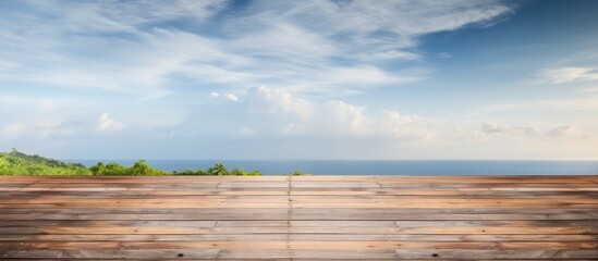 Aufkleber - Wooden planked surface in foreground with a serene coastal view and blue sky in the background ideal for promotional content and text placement