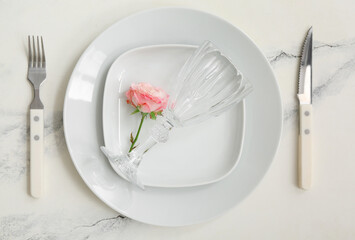 Wall Mural - Composition with white clean plates, flower, cutlery and glass on marble table