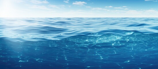 Aufkleber - Translucent blue gradient water with reflective texture and soft waves under a bright sky with light clouds at the top left corner.