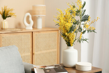 Canvas Print - Vase with mimosa flowers and magazine on table in living room