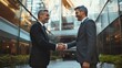 © Ruslan - Two businessmen greet each other with a handshake to represent the success of their business deal or merger.