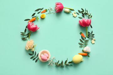 Canvas Print - Frame made of Easter eggs, flowers, green leaves and decor on turquoise background