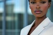 © Vibu design  gallery - Close-up portrait of a stylish Black woman in a beige blazer, exuding confidence and sophistication.