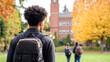 © Eva - An American male student wearing his backpack is walking on the campus of Washington State University, with other students visible in the background.