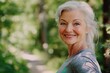 © Alexander Chaykin - Smiling woman enjoying outdoor activity in a wooded trail.