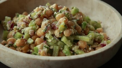 Wall Mural - delicious healthy salad with chickpeas, cucumber, and feta cheese close-up