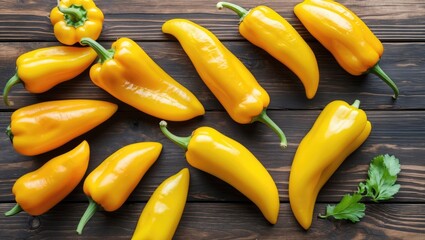 Poster - Fresh yellow peppers arranged on a rustic wooden table, showcasing their vibrant color and natural textures. Ideal for culinary and food designs.