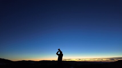 Wall Mural - amateur astronomer looking at the evening skies, observing planets, stars, moon and other celestial 