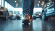 © 楠 刘 - Close-up of a person’s feet walking into a car dealership showroom, captured from a low angle with a slight upward tilt, highlighting the entrance and first impression of the automotive environment.