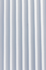 Wall Mural - straight vertical line grooves in white snow surface textured background