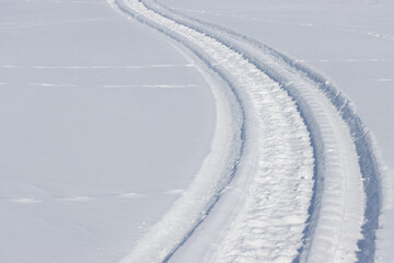 Wall Mural - curved snowmobile tracks on fresh white winter snow