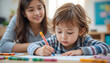 © Muhammad - Young child focused on coloring a picture with vibrant crayons while an attentive adult watches lovingly, fostering creativity and learning