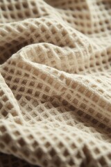 Poster - A close-up view of a blanket on a bed, perfect for use in interior design, home decor, or fashion contexts