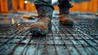 © RONNY - Muddy construction boots on reinforcing steel grid