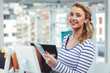 © WavebreakMediaMicro - Holding tablet in modern office, businesswoman embracing technology with smile