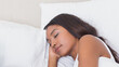 © wavebreak3 - Woman peacefully sleeping in bed, enjoying restful sleep at home, copy space